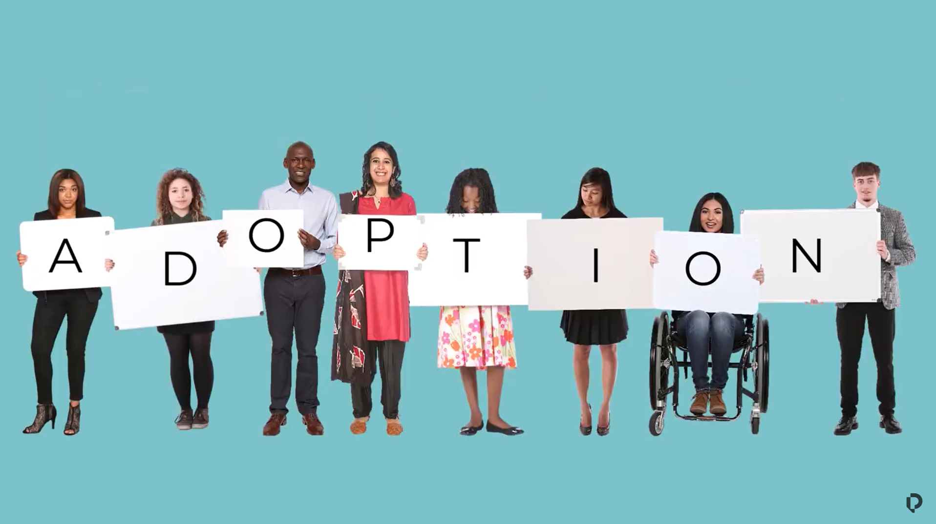 Group of people holding letters that spell adoption